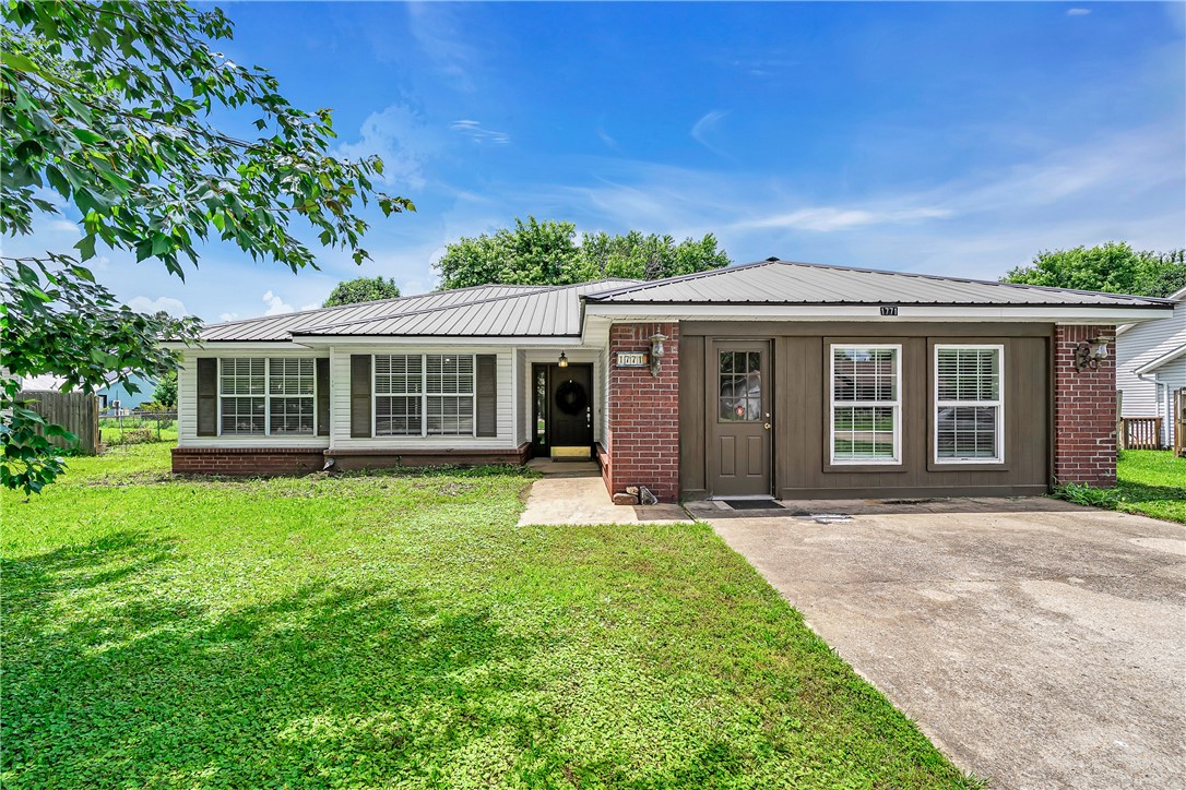Welcome to 1771 Rosewood Lane in charming Elkins — where small-town warmth meets everyday convenience! This well-loved, one-owner ranch home offers 3 bedrooms, 2 baths, and 1,828 square feet of comfortable living space. You'll love the brand-new water heater, newer HVAC, and a metal roof that's only about 8 years old — major systems already handled for you. Fresh luxury vinyl plank flooring flows throughout, giving the home a clean, updated feel. The converted garage creates a huge second living area, perfect for entertaining, a playroom, or a home office. A cozy wood-burning stove adds warmth and character, while the covered patio and fenced backyard are great for relaxing outdoors. A large storage building gives you extra room for all the extras. Situated near shopping yet tucked into a quiet subdivision, you're just a short drive from Fayetteville. This one checks a lot of boxes. Come see it for yourself! (Listing agent is related to Seller)