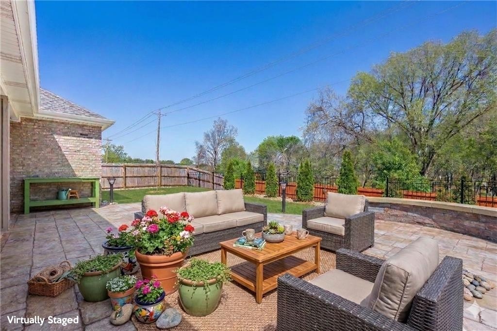 Move-in ready & built in 2024, this gorgeous 4-bedroom, 2.5-bath home with a 3-car garage offers modern style, functional design, & low-maintenance living. The desirable layout creates a bright, airy feel with seamless flow between the living, dining, & kitchen spaces, ideal for everyday living & entertaining. The chef’s kitchen features quartz countertops, abundant cabinet storage, & a large center island ideal for gathering. The spacious living room is anchored by a cozy gas fireplace & filled with natural light from three oversized windows overlooking the backyard. Outside, find an extended decorative concrete patio & beautifully landscaped backyard, along with green space beyond creating a private outdoor retreat for relaxing or entertaining. 2.6 mi-Coler Mtn Bike Trail & 6.3-Downtown Bentonville. Additional upgrades include: widened driveway & premium epoxy-coated garage floor for added durability & style. This turnkey home blends comfort, convenience, privacy, & modern finishes in one exceptional package!