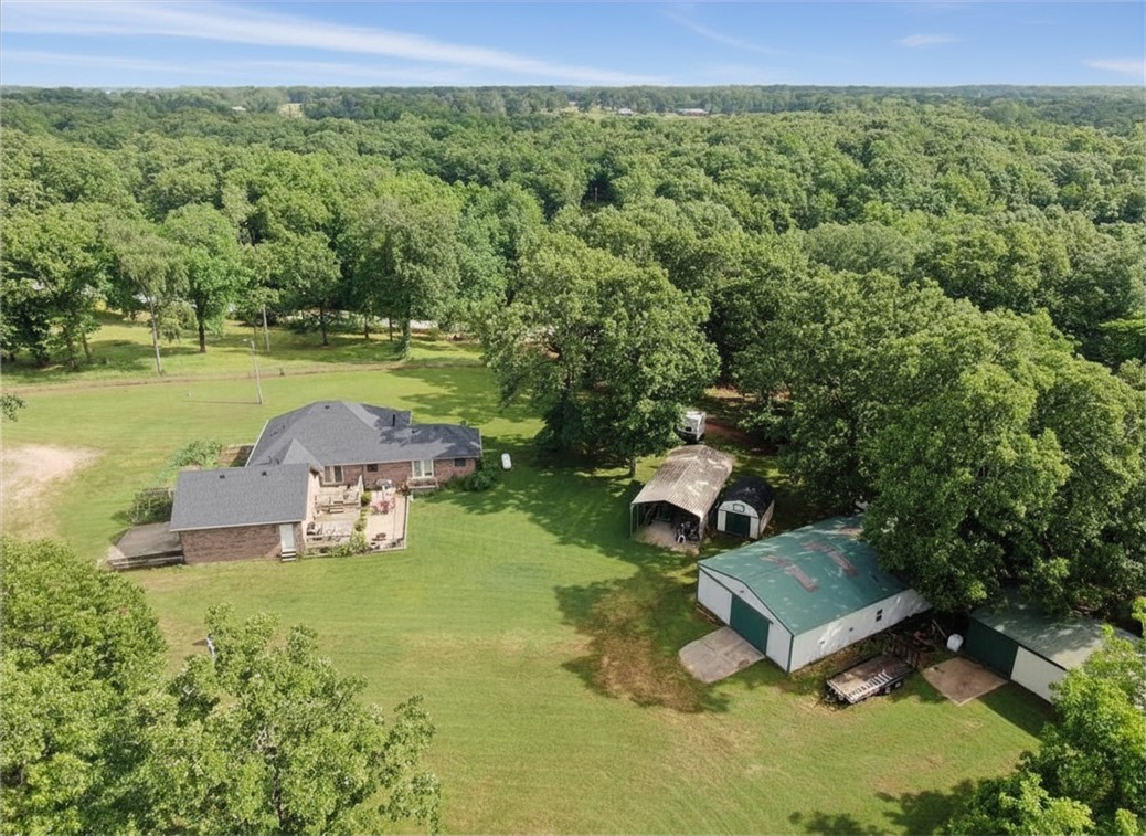 Escape to peaceful country living just minutes from Siloam Springs! Nestled on 3 secluded acres at the end of a quiet road, this all-brick home is ideal for a hobby farm or for those who love privacy and nature. Outdoor features include a 30x50 shop, 24x30 barn, attached 2-car garage, large carport, and chain-link fenced yard for pets. Enjoy the covered front porch and spacious back deck overlooking serene surroundings. Inside, this recently remodeled 3-bedroom, 2-bath home offers new flooring, fresh paint, and an open living/dining area leading to an eat-in kitchen with all-new appliances, including a commercial-grade convection oven. A large laundry room with built-in cabinetry adds storage and convenience, while a pellet stove brings cozy charm. A raised garden area is ready for your dream garden. If you’ve been searching for quiet country living with room to spread out that is minutes from town, this property is a must-see! Call today to schedule your private showing.