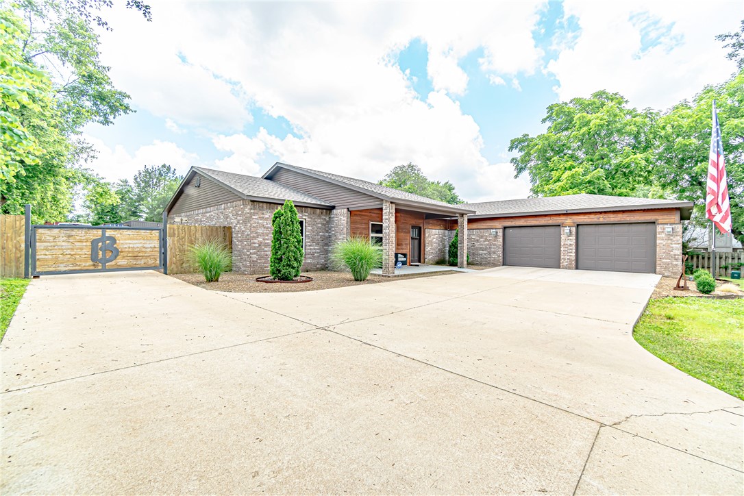 One of a kind ONE ACRE property featuring modern home with 2 exterior buildings in the heart of Bentonville off Central. Home has possibilities of on-site mother in law quarters or an AIRBNB apartment. Terrific opportunity to run a business or place for all your hobbies/toys. The kitchen, dining space, and living room display a flowing open floor plan. The owner's suite features wood panel accents, huge walk in closet, and large bathroom with jetted tub. Custom amenities such as the movie theater and workshop make this home truly unique. The backyard is an entertainer's paradise with a private hot tub enclosure and outdoor dining area. Home has option for 4th BR in place of Media room if desired. Possibilities are endless with the flexibility of this property and home. Building 1:30x40 w/ heat/air, loft and full bath Building 2:25x40 with heat