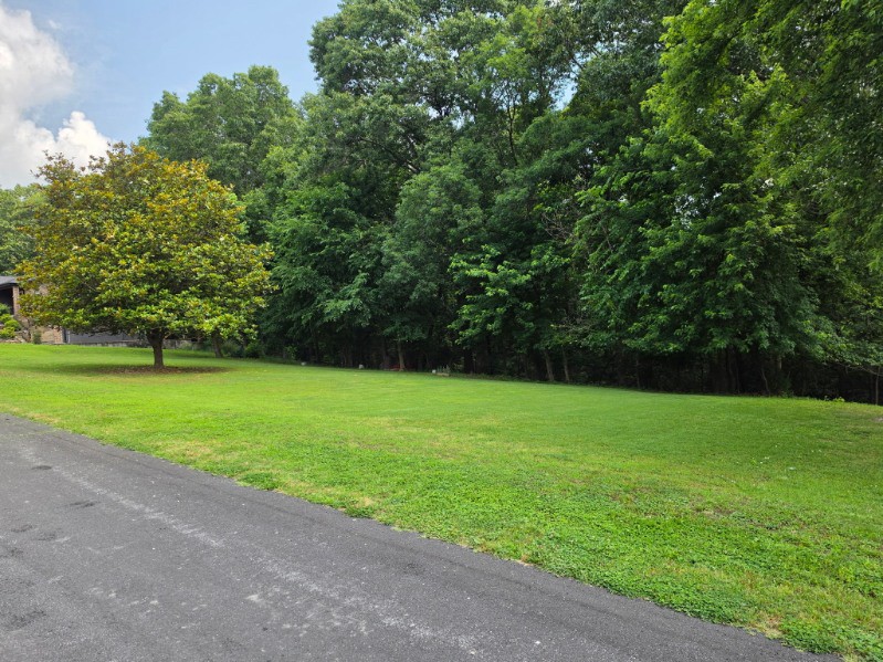 Rare Bella Vista flat lot! This .35-acre homesite is Metfield area. Offering excellent wooded views and provides an ideal, cost-effective building site. City sewer is available at the street—a highly sought-after feature in Bella Vista. Enjoy a true bike-in, bike-out location with direct access to the Back 40 singletrack trail system and the paved Razorback Greenway, both just around the corner and easily reached by bike. Walk to the Metfield Golf Course and Clubhouse featuring pickleball courts, swimming pool, and fitness center. A great opportunity to build your dream home in one of Bella Vista’s most sought-after outdoor lifestyle areas.