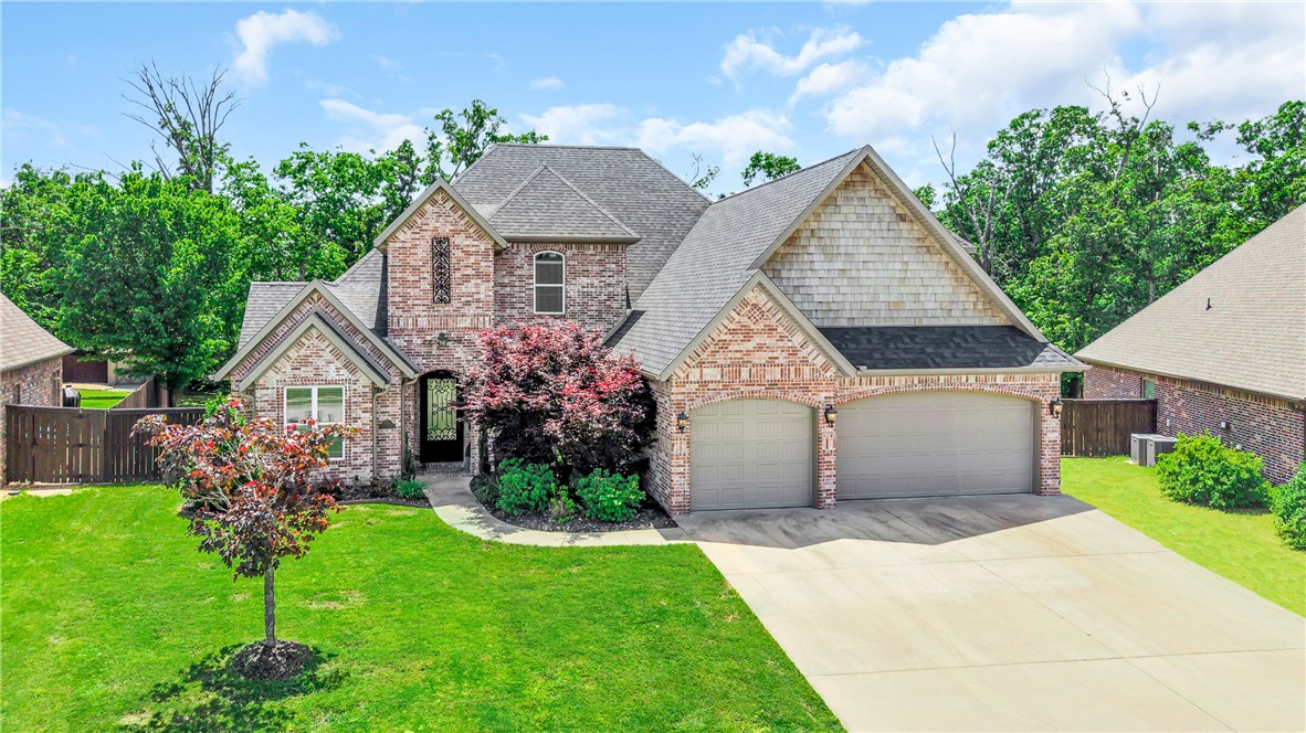 Imagine mornings picking fresh fruit from your own cherry, apple, or pear trees before walking to the community pool. Located in a quiet cul-de-sac close to downtown Bentonville and the new WalMart campus, this stunning 5-bedroom, 4.5-bath retreat offers the perfect blend of comfort and intentional living — a main-level primary suite for effortless everyday life, a home office, a bonus media room for family movie nights, and a covered patio with a brick firepit made for lingering evenings outdoors. Beautiful built-ins, a gas fireplace, and warm wood floors set the tone inside, while mature trees and full front-to-back irrigation complete the picture outside. Recent updates include a new roof, garage doors, and water heater (2024), carpet, upstairs paint, and microwave (2025), exterior lighting (2026), plus a new dishwasher and refrigerator that conveys — meaning you simply unpack and start living. Walkable trails, a playground, pavilion, and basketball courts round out this lifestyle-first community perfectly.