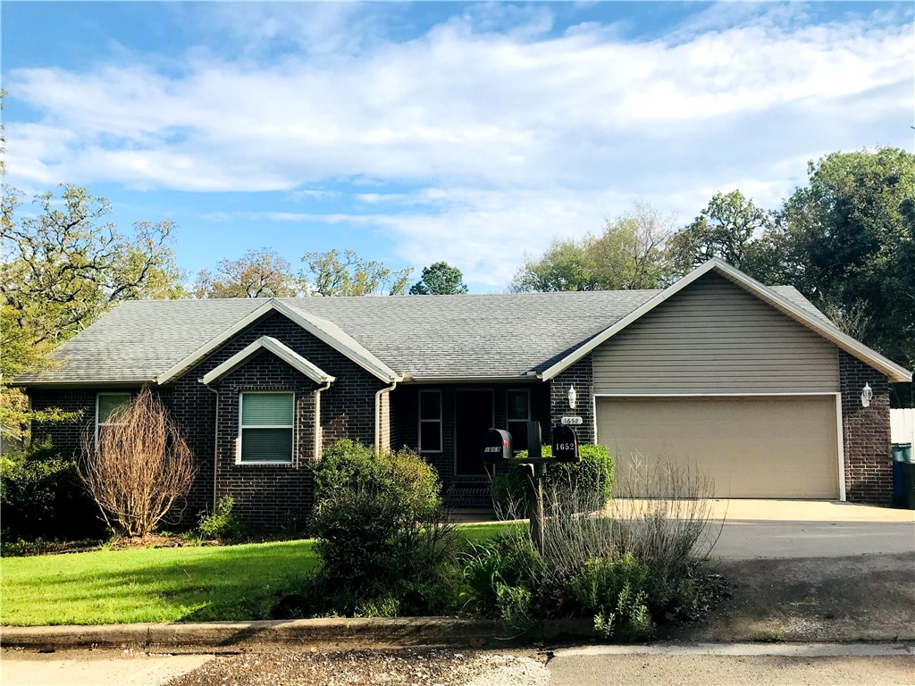 Centrally located in Fayetteville, this extra-clean 3-bedroom, 2-bath home offers wood floors throughout and a spacious master suite. The two-car garage and all appliances included provide everyday convenience, while a covered back porch and large fenced backyard create private outdoor space. Situated near the Razorback campus and transit, and close to a park and the Razorback Greenway, the property combines accessibility with comfortable living.