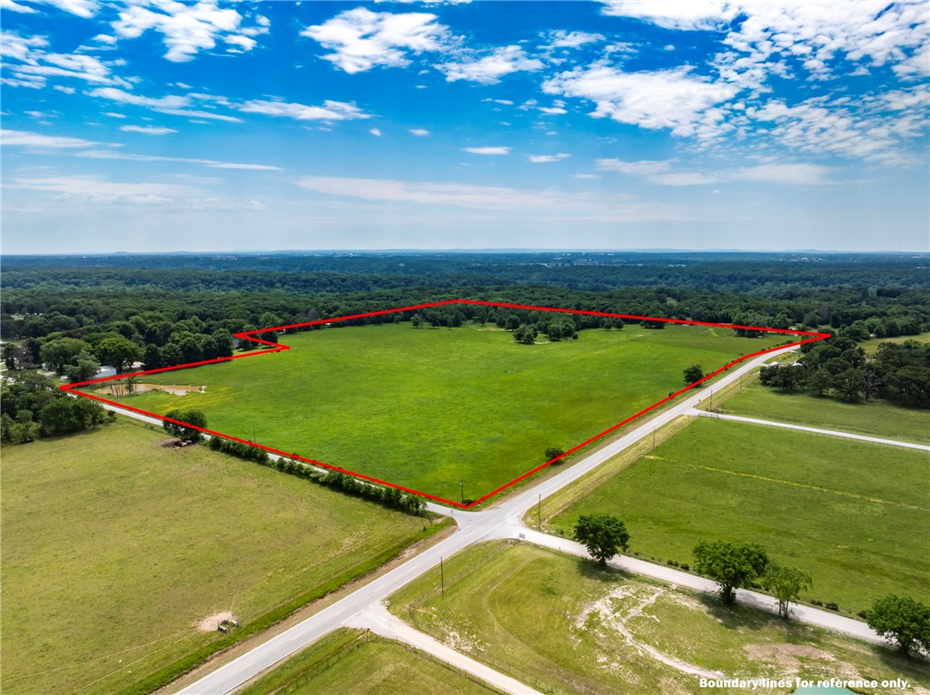 52+ acre improved pasture property with established corrals and working waterers supplied by rural water. Old home site with existing well & septic. Gentle topography, mature tree lines and excellent access from Highway and paved county road, Van Fleet Road. Cleared building sites and room for additional improvements. Development potential, easy to subdivide for multiple building sites. Possibilities are endless. Also, seller is willing to survey and sell by listing the property in 10, 25, 37 acre parcels. See MLS#1328527 (37 Acre parcel). MLS#1347744 (25 Acres)  & MLS#1347753 (10 Acres).