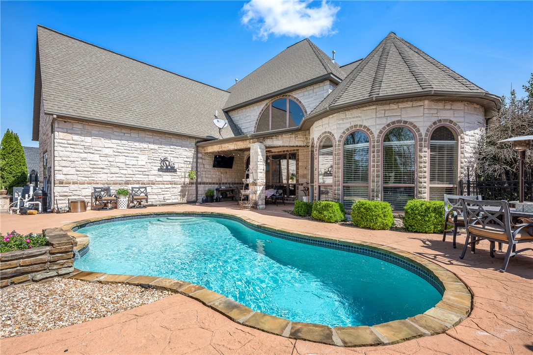 Welcome to a beautifully updated home in the gated Creekside community, ideally positioned between the Pinnacle Hills and Pleasant Grove areas for unmatched convenience to shopping, dining, and I-49. This meticulously maintained residence offers a refined blend of space, function, and style, with a backyard oasis. The grand two-story entry creates an impressive first impression. The well-designed layout features multiple living and entertaining spaces, a gourmet kitchen with generous storage, and a spacious primary suite on the main level. Upstairs, discover versatile bonus space, elegantly appointed as a home theater and your own private gym. Step outside to a private backyard retreat designed for relaxation, complete with a pool, covered patio and additional open patio. Enjoy direct access to the Blossom Way Trail, along with proximity to Rogers High School and all of Northwest Arkansas. This is a rare opportunity to own a thoughtfully updated home in one of Rogers’ most desirable locations.
