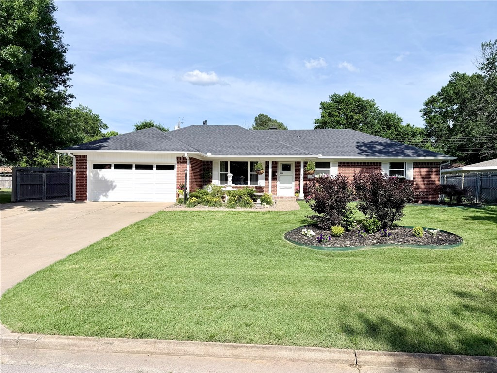 Welcome to this lovely, established home in one of Springdale's most convenient locations. Positioned near its vibrant downtown, many frequent Springdale destinations are a remarkable short distance away.  The interior of the home features three bedrooms and two updated full bathrooms.  Two bonus rooms offer the perfect spaces for a home gym, office , den, or additional bedrooms.  On the exterior this all-brick home boasts lush landscaping with underground sprinkler systems, new gutters, a new roof, a large fully fenced back yard and a concrete driveway leading around the home to one of your biggest gems!  There is a custom detached garage behind the home that was built to perfectly match the home.  The building is fully heated and cooled with two new indoor mini split units.  The building is currently being used for storage, but could easily be converted to an ADU for extra rental income, a guest house, a home business, a cinema, or man cave/she shed.  Book your showing today and come see this charming home.