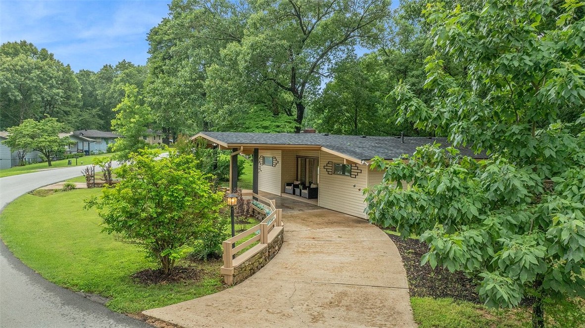 One of a kind! Completely Remodeled with the utmost care! Contemporary & Classy meet with grace and ease! Living Room with Cathedral ceiling & beamed.  Entry =Unique 2 huge closets. Trails so close put one of your bikes in the entry closest! Living, dining, kitchen all open areas. Wall of windows in living area which encompasses the dining area. Large kitchen with great working area, painted cabinets, breakfast area + breakfast bar. 3 bedroom, 2 bath with a circular driveway and a 2 car carport that can also be utilized as a patio area! The carport doubles for a patio that is covered for barbecues, entertaining even with an additional sitting area one step up and almost totally across the front of the carport area. Finding a new home with the updates this home has is exciting! Custom closet doors, huge walk in tile shower. Nice bath also with tub, tile surround/ shower. Gorgeous front with huge front yard and privacy fenced backyard. The lot is amazing=a half moon so there so much room for outdoor activities.