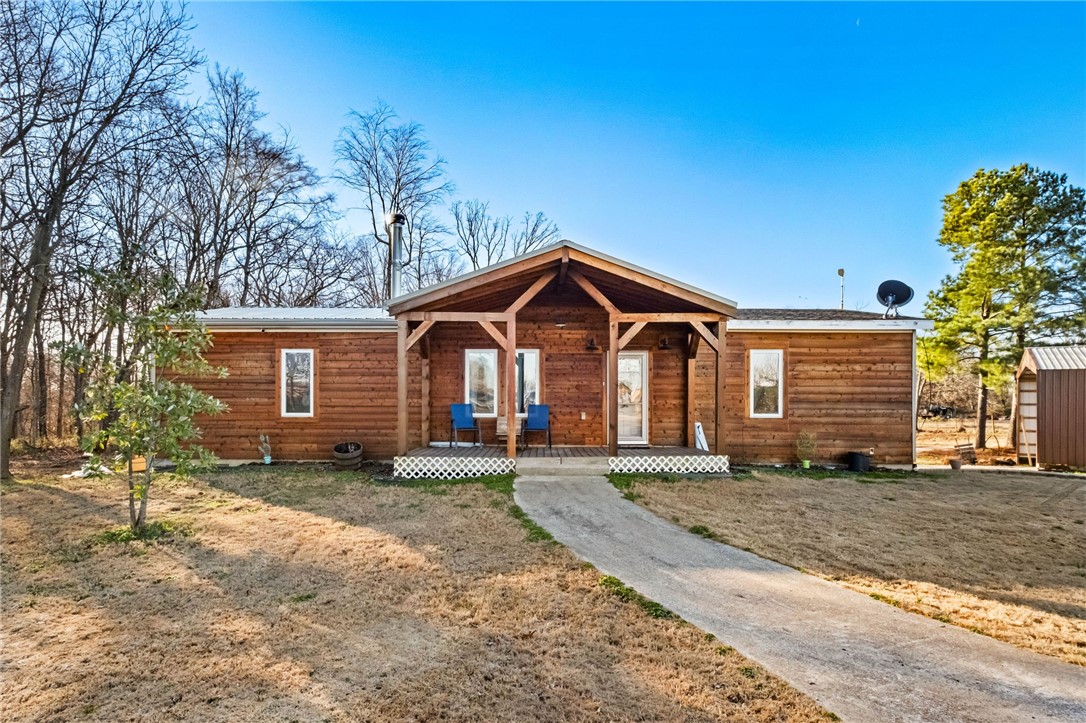 10 ac mol w/ 3/2 homestead! There is development taking place in the area; join in the fun, build your dream home or live here enjoying what the Sellers hard work! Welcome to Taylor Orchard Road, Gentry, AR! Offering a beautiful rustic doublewide on a permanent foundation (also has concrete runners) w/lots of extra characteristic (beams, etc), 3/2, MULTIPLE decks, HOT TUB, Wood burning stove, top tier oven/range (propane), flooring is new throughout (carpet and vinyl plank), metal roof is being installed currently (new), SOLAR PANELS (28 ft) electric is $38/mo! *paid off at closing*, a well w/spickets (never any issues for seller), city water at the road (buyer to satisfy himself), internet, security, Propane tank is owned, ventless propane heater (additional heat source in BR), HVAC/WH elect., woodstove (Jewel brand), Shop 24x50 concrete pad, woodstove, gas heater (in shop), container with lean-to for livestock to convey, RV CAMPER parking with water/electric connections, fenced for your animals! Windows have Wty!