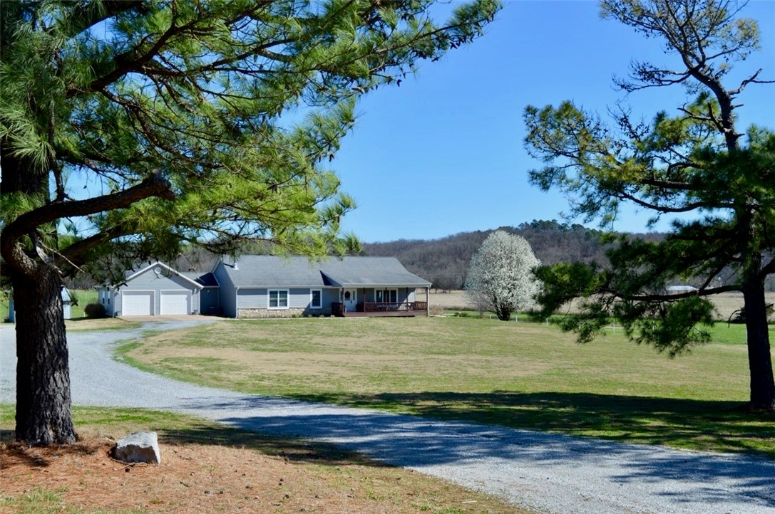 We've long admired this beautiful spot and are thrilled to present a unique farm located on the western side of Benton County. Picture yourself on approximately 28 acres, just north of Spavinaw Creek and off Hwy 43. The charming home welcomes you right from the road, featuring a lovely front porch that leads directly into a cozy living room and an inviting open kitchen. Enjoy a cup of coffee on the back deck or make your way to the lower level, where you can find additional living space with a fireplace, bedrooms, and room for games. There is also a fantastic shop space perfect for running your small business. And for the livestock enthusiasts, woodworkers, or DIY aficionados this place has everything you need to bring your dreams to life. Come explore the possibilities; you wont regret it! The sellers are very motivated to close the sale and make their next move. Don't hesitate to view the place and make an offer!