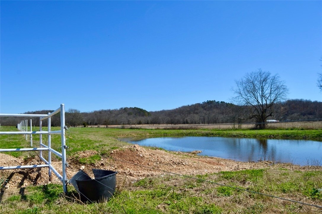 We've long admired this beautiful spot and are thrilled to present a unique farm located on the western side of Benton County. Picture yourself on approximately 28 acres, just north of Spavinaw Creek and off Hwy 43. The charming home welcomes you right from the road, featuring a lovely front porch that leads directly into a cozy living room and an inviting open kitchen. Enjoy a cup of coffee on the back deck or make your way to the lower level, where you can find additional living space with a fireplace, bedrooms, and room for games. There is also a fantastic shop space perfect for running your small business. And for the livestock enthusiasts, woodworkers, or DIY aficionados this place has everything you need to bring your dreams to life. Come explore the possibilities; you wont regret it! The sellers are very motivated to close the sale and make their next move. Don't hesitate to view the place and make an offer!