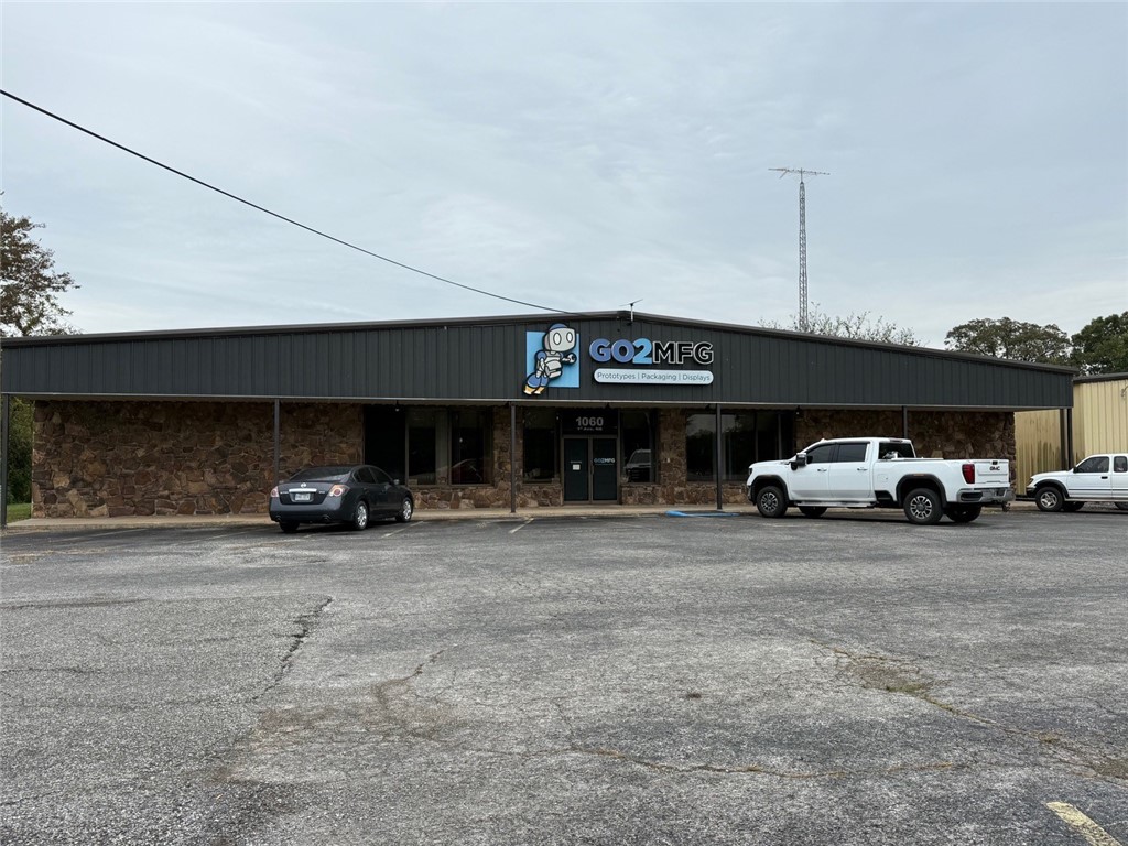 This well-conceived property features three interconnected buildings, joined by breezeways, each serving a distinct function that enhances flexibility and revenue potential.  
Primary Building (~12,000 SF, climate controlled)
Lobby, restrooms, offices, kitchenette, storage, and open display/assembly floor.
Ideal for light manufacturing, showroom, R&D, or hybrid usage.

Large Open Warehouse (~9,700 SF)
High-clearance space, loading dock, overhead door access
Suitable for inventory storage, distribution, light fabrication, or logistics operations 

Garage / Residential Component (~1,697 SF per level)

Ground floor: four-bay garage / workshop

Upper floor: carpeted apartment with 2 bedrooms, kitchen, living area, bath, laundry

Offers optional owner-occupancy, on-site management, or supplemental rental income