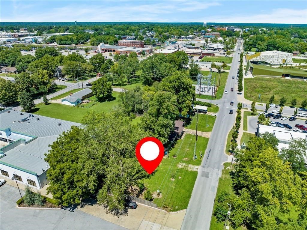 Perfect opportunity to own directly across the street from the new Thaden Middle School opening August 2026! Zoned for Residential or Commercial offering endless possibilities for this property in Downtown Bentonville! The downtown core zoning paired with the location on Main Street gives you access to everything happening around Bentonville. Zoned Commercial for almost any business - Reach out & I will send you the list! Zoning: Residential Mixed Use - Retail/Office 1st Floor, residence above, up to 8 stories Dwelling - Condominium Dwelling - Multi-Family Dwelling - Townhouse or Rowhouse