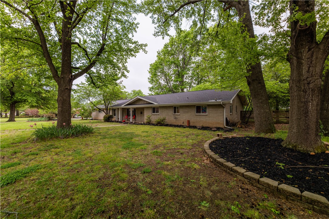 Welcome to a charming ranch-style home nestled on over three-fourths of an acre. This spacious one-level home features 4 bedrooms, 3 bathrooms, and more than 3,200 square feet of living space. Large rooms and multiple living areas create an ideal setting for both everyday living and entertaining, while the 400 sq. ft. sunroom and backyard provide an inviting space for the whole family to enjoy. The kitchen, primary bathroom, and utility room feature custom maple cabinetry and granite countertops. Extensive renovations completed in 2005–2006 blend vintage charm with modern updates, offering the perfect canvas to add your own personal style. Recent improvements include a brand new roof, new hot water heater, dishwasher, fireplace and chimney improvements, updated bathroom fixtures, and new carpet. Set among mature trees in an established neighborhood and located in close proximity to I-49, JB Hunt Park, and Downtown Springdale, this home presents an ideal blend of space and convenience.