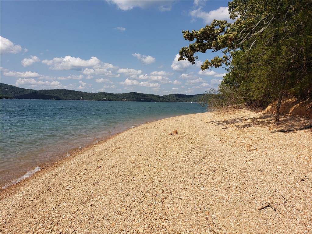 Rare Beaver Lake Opportunity – 3 Acre Lot with 1,000+ Ft of access to a Pebble Beach! Take a stroll down to your own Beaver Lake lakefront property with over 1,000 feet of pristine public pebble beach frontage. Dramatic bluffs offer flexible building options: perch your home up top for breathtaking views, or build down low for effortless walkability to the water. Property includes an approved septic design and an available well site, saving you time and hassle. Seller is even offering a charming cottage design ready to bring your vision to life. Just minutes to Starkey Marina to launch your boat, and a short drive to downtown Eureka Springs for dining and shopping. Whether you're dreaming of a private retreat or a forever lake home, this one has it all. Schedule your showing today!