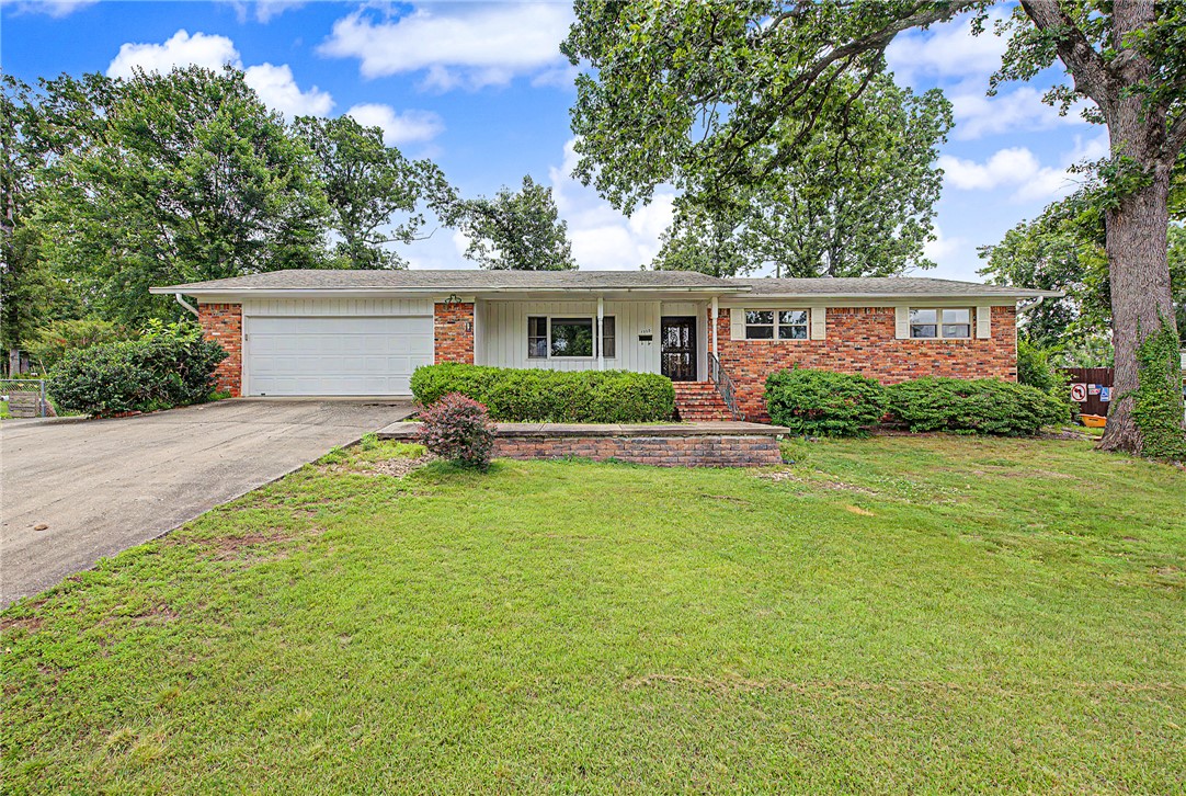 Conveniently located in the heart of Rogers, this well-maintained home offers a fantastic opportunity to add your personal touch while enjoying a prime location close to schools, shopping, dining, parks, and everyday amenities. Inside, you'll find spacious living areas, a cozy brick fireplace, abundant natural light, and a functional floor plan designed for comfortable living. The kitchen features ample cabinet and counter space with an adjoining dining area perfect for gatherings. Generously sized bedrooms provide plenty of room to relax, while large windows throughout create a bright and inviting atmosphere. Enjoy the private backyard with mature landscaping and space for outdoor entertaining or gardening. Whether you're looking for a primary residence, investment property, or a home to update and make your own, this Rogers property offers endless potential in an established neighborhood.  This home is an estate sale and Sold As Is No Repairs