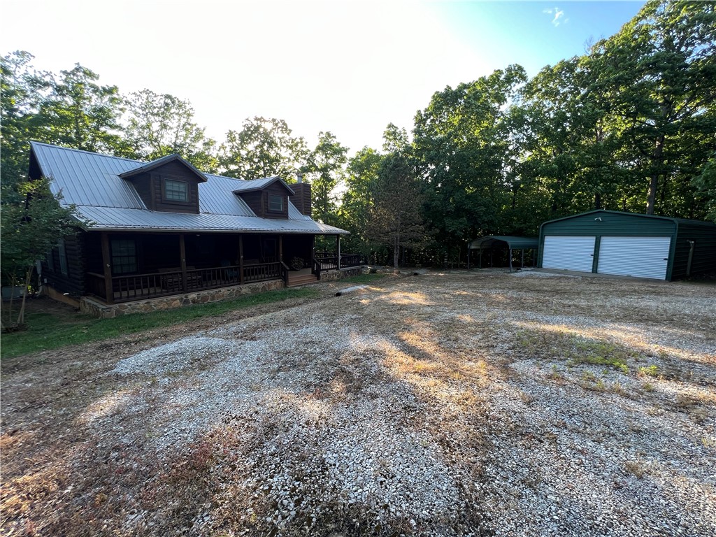 Secluded 3BR-2BA rustic Ozark Mountain log cabin on 15.93 acres m/l!! This 1,504 SF home was built in 2004 from 8 inch cypress logs with dovetailed corners and features a native stone wood-burning fireplace, loft, cathedral ceiling, under-the-stairs pantry, 2 large covered porches, and metal roof. This property also features a 20x30 metal shop building with concrete floor and electric plus a one car carport. The land has gentle rolling topography and approximately 6 cleared acres with fencing, a stocked pond, and a healthy variety of native trees including redbuds, dogwoods, and persimmons. Great hunting environment! Home sits off the dead-end road and is only 10 minutes from the Buffalo National River Park and the Steel Creek access point. Call today to schedule a showing!