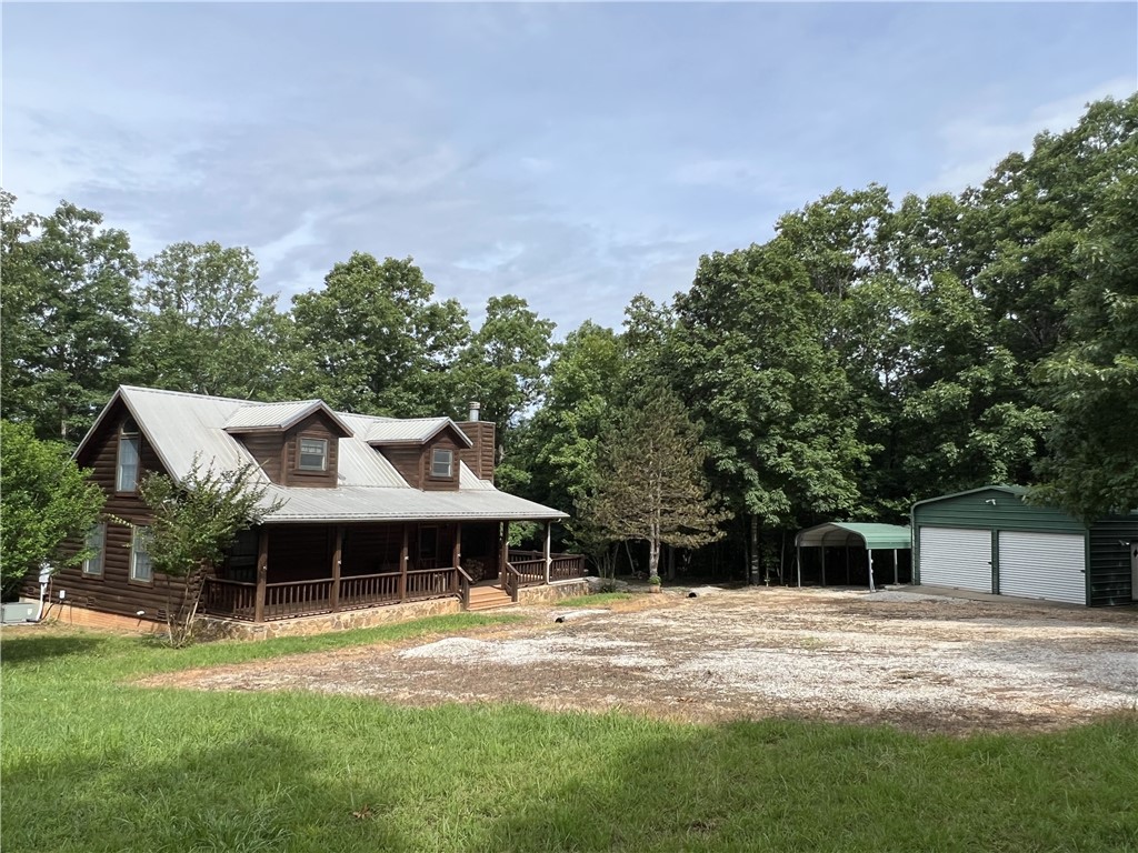Secluded 3BR-2BA rustic Ozark Mountain log cabin on 15.93 acres m/l!! This 1,504 SF home was built in 2004 from 8 inch cypress logs with dovetailed corners and features a native stone wood-burning fireplace, loft, cathedral ceiling, under-the-stairs pantry, 2 large covered porches, and metal roof. This property also features a 20x30 metal shop building with concrete floor and electric plus a one car carport. The land has gentle rolling topography and approximately 6 cleared acres with fencing, a stocked pond, and a healthy variety of native trees including redbuds, dogwoods, and persimmons. Great hunting environment! Home sits off the dead-end road and is only 10 minutes from the Buffalo National River Park and the Steel Creek access point. Call today to schedule a showing!