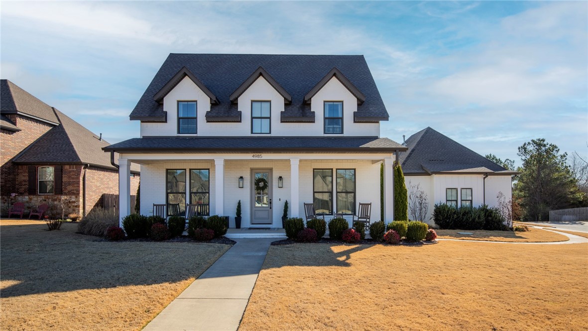 Here's what you've been waiting for! Take a look at this quality-crafted designer home in the desirable Sloan Estates of East Fayetteville. The sensible open floor plan provides all of the spaces you'd need, plus some thoughtful bonuses like a Butler's pantry/coffee bar area with a second sink, a front bedroom that could also be the perfect playroom or office, charming powder bath, and plentiful storage throughout. The first floor primary suite is spacious with a massive walk-in shower and closet plus a soaker tub.  The screened-in back porch is perfect for enjoying sunrises, dining, and lounging all year round. Large corner lot. The wide wooden stairs with custom iron railings lead to a large landing with three additional bedrooms, two with a shared bath and the third with its' own ensuite.  House also includes 240V plug in the garage for EV charging and full irrigation. Don't miss this well cared-for, comfortable home in a charming neighborhood!