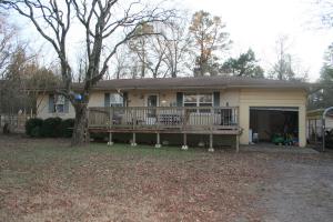 Close to town, but at the end of a dead end road, you will find this secluded 3 bedroom 1.5 bathroom brick home. This home offers a front deck with gates, making it safe for young children or pets. Comes with a one car garage and an additional carport.  There is a storm cellar in the back yard, and a playset the kids will love. Fenced backyard with garden area and a place for chickens. Come and see this listing today!