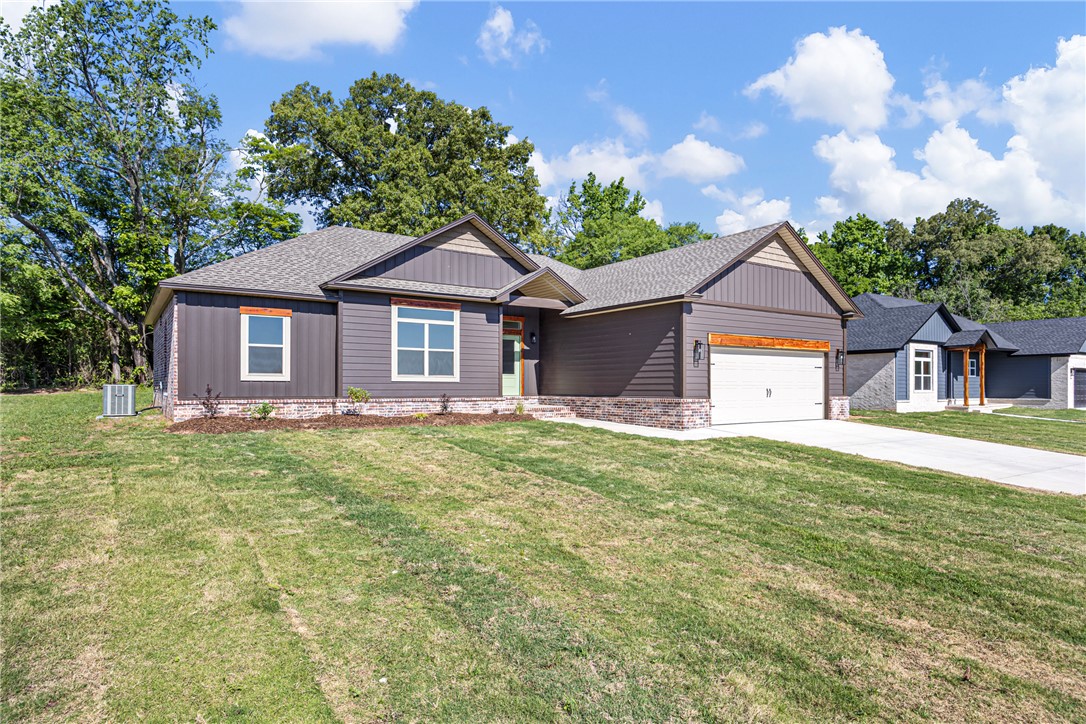 THIS HOME CHECKS ALL THE BOXES!  Quality throughout this 4 bedroom, 2 bath brick and siding home. Beautiful, spacious kitchen and dining with quartz countertops and walk-in pantry. Large open living room is the central focus of the home with large windows with a view to the outside covered area.  Split floor plan, beautiful custom finishes throughout.  Master bath features double vanity, separate shower and jetted garden tub, two walk-in closets, private toilet and linen closet.  Hall bath is well-designed to accommodate 3 bedrooms with door separating tub/toilet and vanity area.  Call about it today!