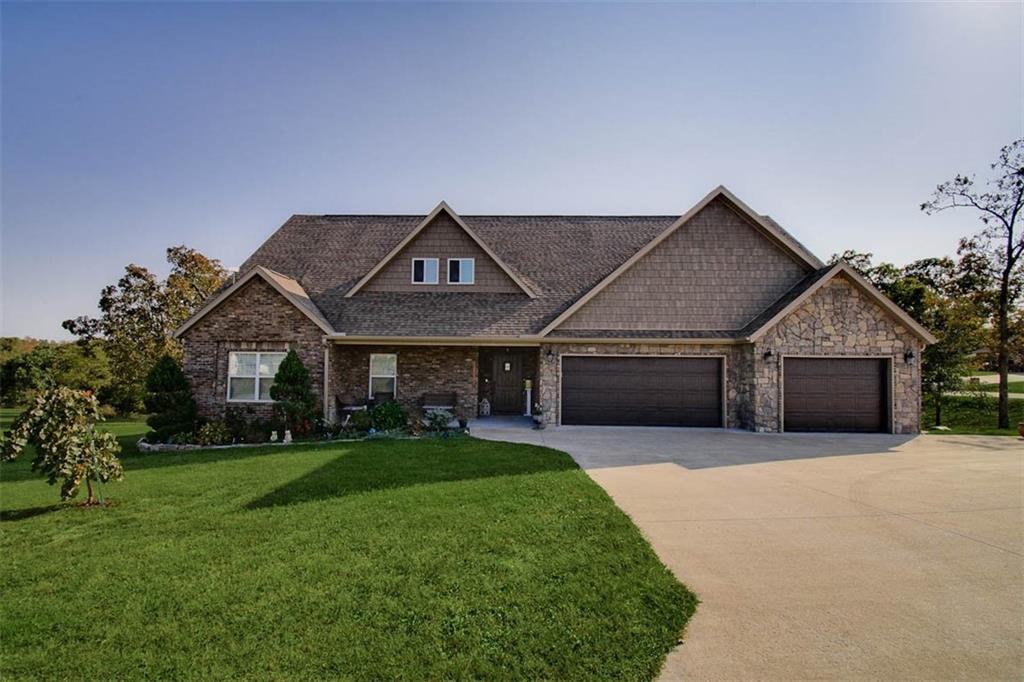 Owner Financing Option Available! Welcome to charming country living on 1 acre w/ the convenience of city amenities! This custom-built home in Moonlight Valley Subdivision blends high-end finishes, thoughtful design, ample storage, & custom touches throughout! The main level features wood-look tile flooring throughout, open-concept design featuring a gorgeous chef's kitchen, & 3 generously sized bedrooms! The spacious, sunlit primary suite includes a large walk-in closet & spa-inspired en-suite. Upstairs, find an additional room/flex space w/ a bathroom, a versatile bonus/media room, & a dedicated office space, perfect for work or study. Wait until you see the upstairs secondary kitchen, cleverly concealed behind built-in cabinetry boasting gorgeous finishes. Step outside & enjoy the covered back deck with a stone-surround fireplace that overlooks a peaceful wooded area. Located minutes to the bypass and just a short commute to the Walmart Home Office! Also listed ML #: 1344616. Septic design reflects 3 bedrooms.