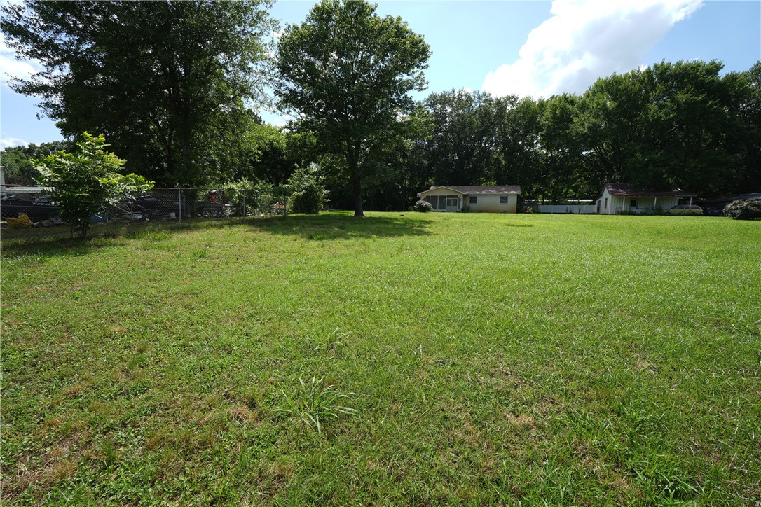 Home in the country, but convenient to town! Very nice older 2 bedroom, 2 full bath home on almost 1.5 acres. Solid wood flooring is a nice touch. Smaller kitchen, with attached dining and large pantry. Includes a generator that is hooked into the electrical service to power receptacles in the home. Roof replaced 2 years ago - and includes the roofer's warranty! Relax on the large, screened front porch and enjoy the beautiful views of 2 ponds and the countryside.