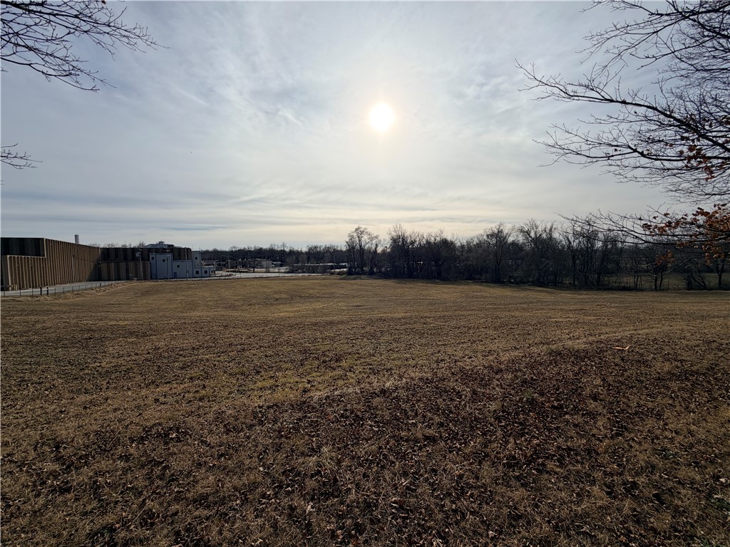 Exceptional investment and development opportunity on 7.63± acres with a new survey completed, located on a corner lot inside city limits in the heart of Northwest Arkansas. Surrounded by ongoing industrial growth and new developments, this property offers outstanding future potential. All utilities available at the street, including natural gas, with an additional main sewer line running across the property, adding significant development value. A rare chance to secure a sizable tract in a rapidly expanding area.