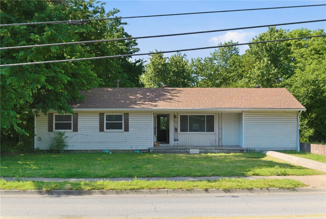 Attention investors and handy buyers — this is the opportunity you've been waiting for. Located in the heart of Springdale, just minutes from downtown and JB Hunt Park, this 3-bedroom, 1-bath home has solid bones and is ready for the right buyer to bring it back to life. The big-ticket mechanicals are already done: HVAC replaced in 2019, newer architectural shingle roof, and new double-pane vinyl windows on the front of the home. Inside, you'll find laminate and wood flooring, an eat-in kitchen, ceiling fans, washer/dryer connections, and an unfinished bonus room full of potential. Outside features a covered patio, a 160 sq ft storage building, and 3-sided fencing. Sold As-Is — priced to reflect condition. No POA fees. Bring your vision and your contractor — this one is priced to move.