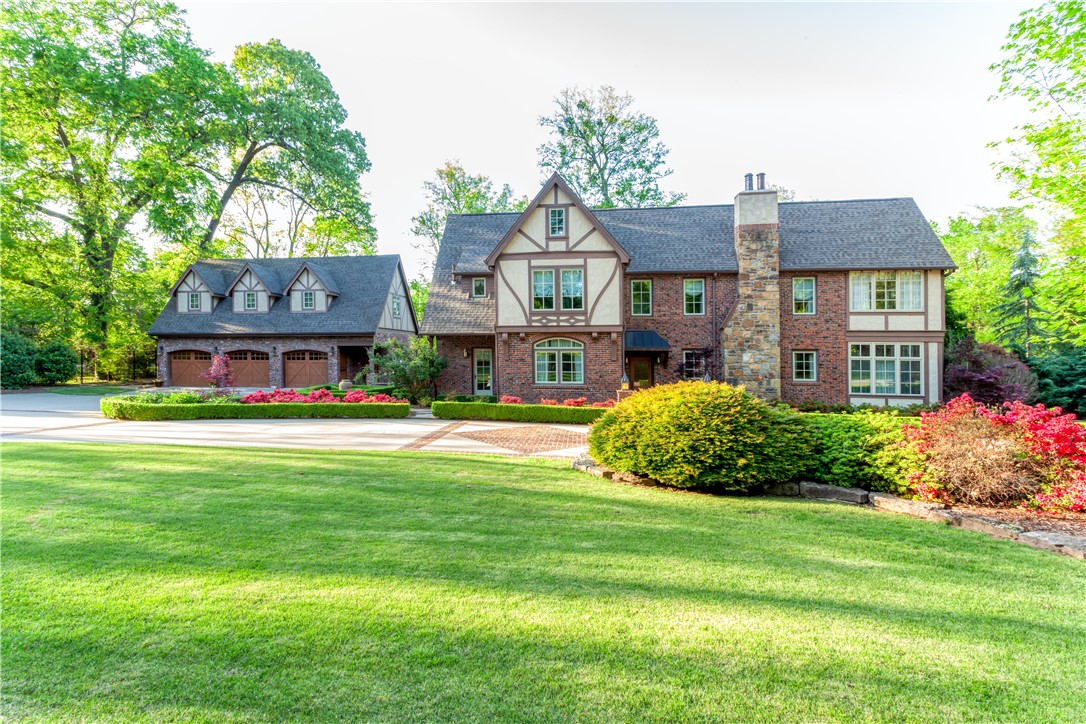 From the road, through the front door, to the backyard, this home will leave you enamored. Located on Fort Smith's Free Ferry Rd, this Tudor style home showcases the beauty and elegance of the 1920's with modern updates such as a gourmet kitchen, Venetian Plaster covered walls throughout, hand carved sinks and mantlepiece, granite countertops, Travertine Tile, new 3 car garage with extra-large bonus room with bathroom and new pool house with ice maker, beverage refrigerator, changing room and bathroom.
