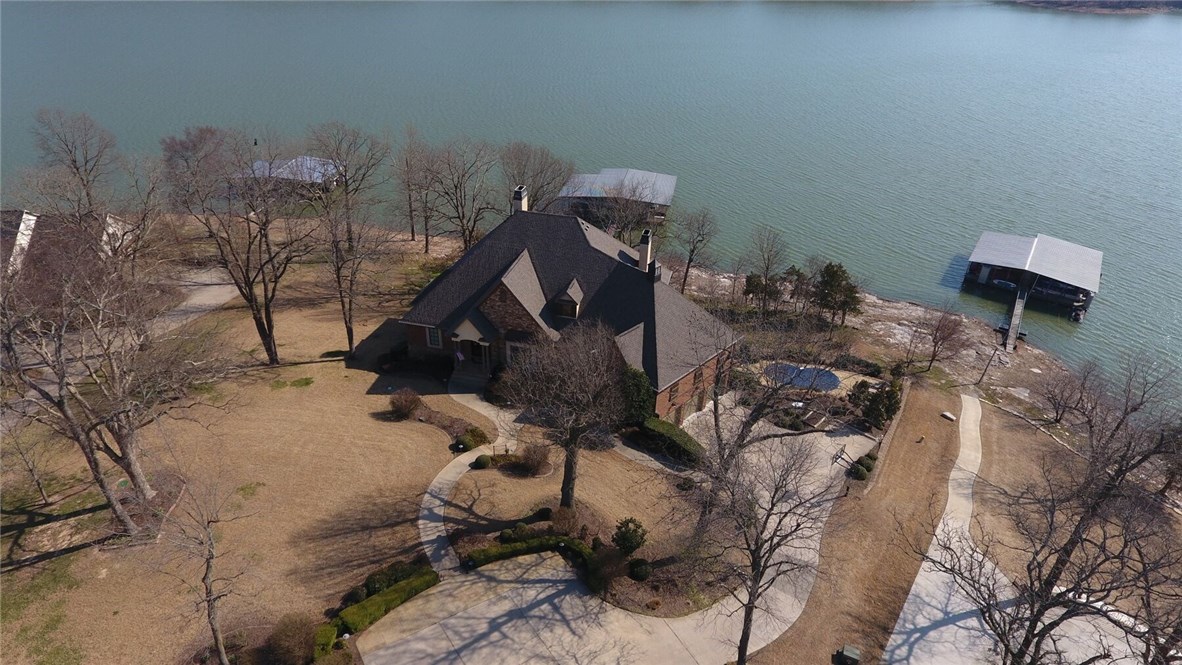 Make your dreams come true! Gated luxury lakefront home. You won't be disappointed in all this fabulous dream home has to offer. 6300 square feet offering pure relaxation for you, your family and friends. 4 stall private boat dock steps from your home w gentle slope. Home features open concept, lake views from most rooms, inground gunite pool, hot tub, a true theatre room complete w bar, an elevator, full decks upper and lower, 2 full kitchens, 6 bathrooms, 2 laundry areas. Welcome to your forever home!!