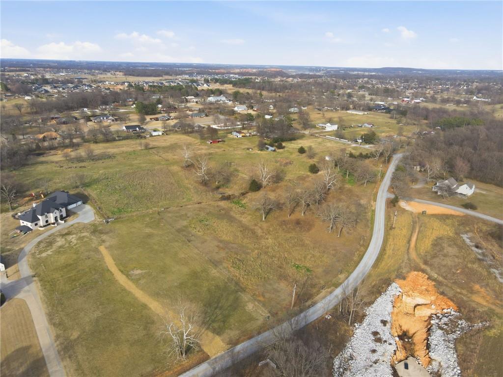 Rare opportunity in Elm Springs-14.43 scenic acres with open views of Elmdale Lake. Gently rolling and picturesque, this property is ideal for a private luxury estate or a builder's showcase project. Peaceful setting with endless potential.