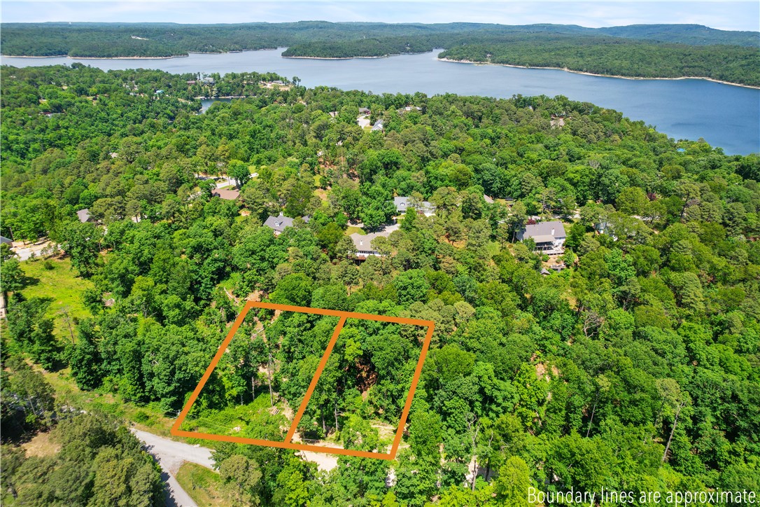 Welcome to Runnymede Subdivision, an established neighborhood, with covenants. Build your dream home on Beaver Lake and take a short stroll to the public beach and boat launch! Lot is partially cleared and a home could be build to enjoy seasonal lake views. The Monument Bike Trails at Hobbs State Park are a few minutes away, and downtown Rogers is 10 minutes from this location. The adjacent lot is also available to purchase!