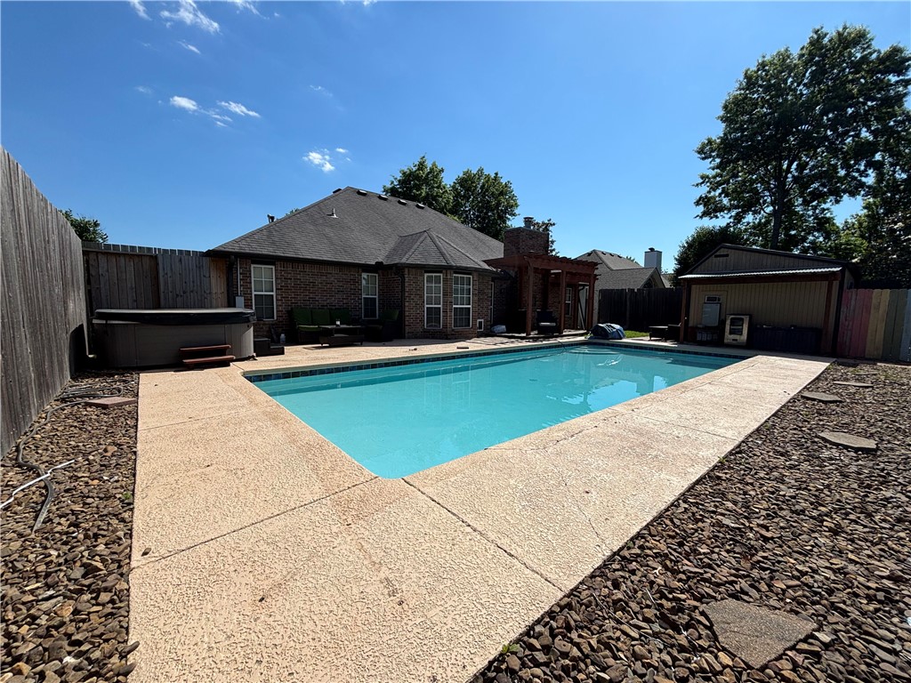 Incredible Rogers Location and Just in time for spring to enjoy your own Large salt water pool and Hot Tub. This 3 Bed 2 bath home also has a dedicated office space.  Master suite includes tray ceiling, large walk in closet and bathroom with dual vanity, shower and soaking tub, Kitchen with stainless appliances, gas range, granite countertops, antique white cabinetry and eat-in kitchen.   Large family room with built in cabinet, tray ceiling and gas log fireplace.  Engineered hardwood floors, extra wide garage and great front patio.