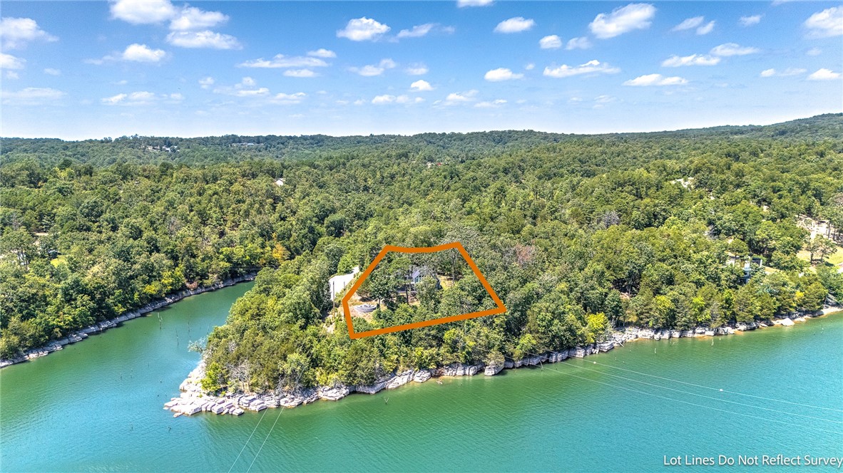 LAKE ENTHUSIASTS…YOUR DREAM HOME AWAITS!!! Welcome to this CUSTOM-BUILT LAKEFRONT BEAUTY nestled on a 1.75 acre lot on gorgeous Beaver Lake featuring a boat slip w/ lift in the easy to access community dock just a short and easy drive away! This STUNNING home was built in 2022 & boasts top of the line amenities throughout! Step into the dreamiest sunroom boasting floor-to-ceiling windows & a vaulted wood ceiling, perfectly framing this amazing setting w/ serene lake views! 2 expansive decks offer the ideal space to dine, entertain & enjoy the lake views! Fabulous open chef’s kitchen is designed to impress & features double ovens, gas cooktop, large island, industrial ice machine & butler’s pantry! Wood burning fireplace in the spacious & charming living room! Top floor master suite & guest suite boast exceptional views! First floor enjoys 2 additional bedrooms, 2 full baths, huge great room w/ sliding doors leading to covered patio! 238 ft of core frontage located in one of Beaver Lake’s finest little coves!