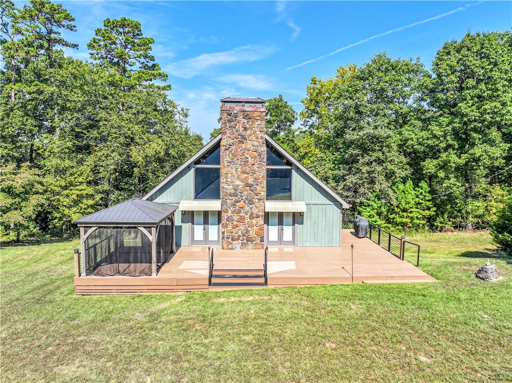 Your own private Ozarks retreat—where privacy, recreation, and convenience come together on 14+ acres. This furnished 3-bedroom, 2.5-bath home features recent updates including a new roof, HVAC, fresh paint, new windows, and new flooring throughout, plus a security system for added peace of mind. A 2-car garage and detached pole barn provide excellent storage or hobby space. Backing directly to Hobbs State Park, enjoy immediate access to a trail leading to the lake—perfect for hiking, biking, horseback riding, or simply soaking in the natural beauty. Whether you're looking for a weekend escape or full-time living, this property captures the essence of lake life and outdoor adventure.
Seller also owns a 2010 24-ft Landau Harbor Cruise Tritoon with Mercury 150HP motor and 24-ft Bear trailer, with a slip at Rocky Branch Marina. Available separately by bill of sale outside the real estate contract.