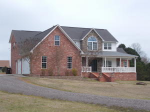Home on the water in Stonegate.  Why build when this is waiting for you right now ?  4 bedrooms and 2.5 bathrooms sitting on 1.38 acres. The open kitchen/living room with a gas fireplace leads onto a covered porch with a view of the water.  Oversized 3 car garage has a 4th bay for equipment storage.   A custom kitchen with stainless steel fridge and island.  The master bedroom has cathedral ceilings with fans and the roomy bathroom has a tub, tiled shower and walk-in closet.  Spaces upstairs includes three bedrooms,  full bathroom, sitting area and space for workout equipment.  Plus an extra storage room.  Downstairs is a home office/study room. An elevated gavel pad with electric service and tie down posts is perfect for an RV and boat.  This home will make some family, very happy !!!