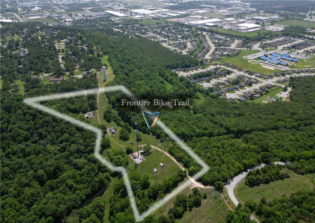 If you have been looking for an opportunity to invest in bicycling in Northwest Arkansas, this is your big chance! This 9.19 acre offering borders the Bayyari Park and Mountain Bike Trails in Springdale.  In fact, a small portion of the "Fronteir Trail" runs right through the property!  You could build an adventure park, or a mountain biking resort, or anything else you can think of to serve the thousands of riders that enjoy our area year round!  There is even a private road that travels the lenth of the property!  This location is amazing.  All it needs is your imagination!
