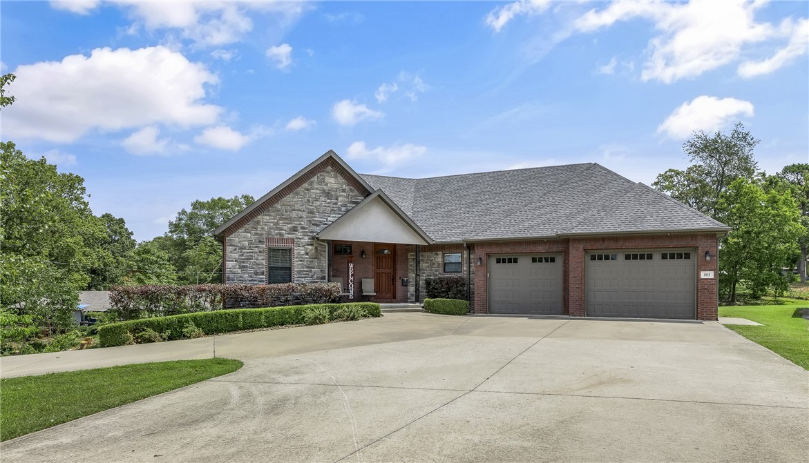 A clear cut winner in Downtown Bentonville! This newer home has a very flexible floor plan, Need an in-law suite or two primary suites? Got it! Multliple living spaces? A real storm shelter? Home office? A yard big enough for a pool? Yes, yes, yes and more! Incredible 52' deep garage, 2 covered outdoor patios, all on a private lot with the bike trail in the front yard. Walk to schools and Park Springs (City park). A half acre lot is rare in this zone. Come see this unique property before it is gone! Photos digitally staged.