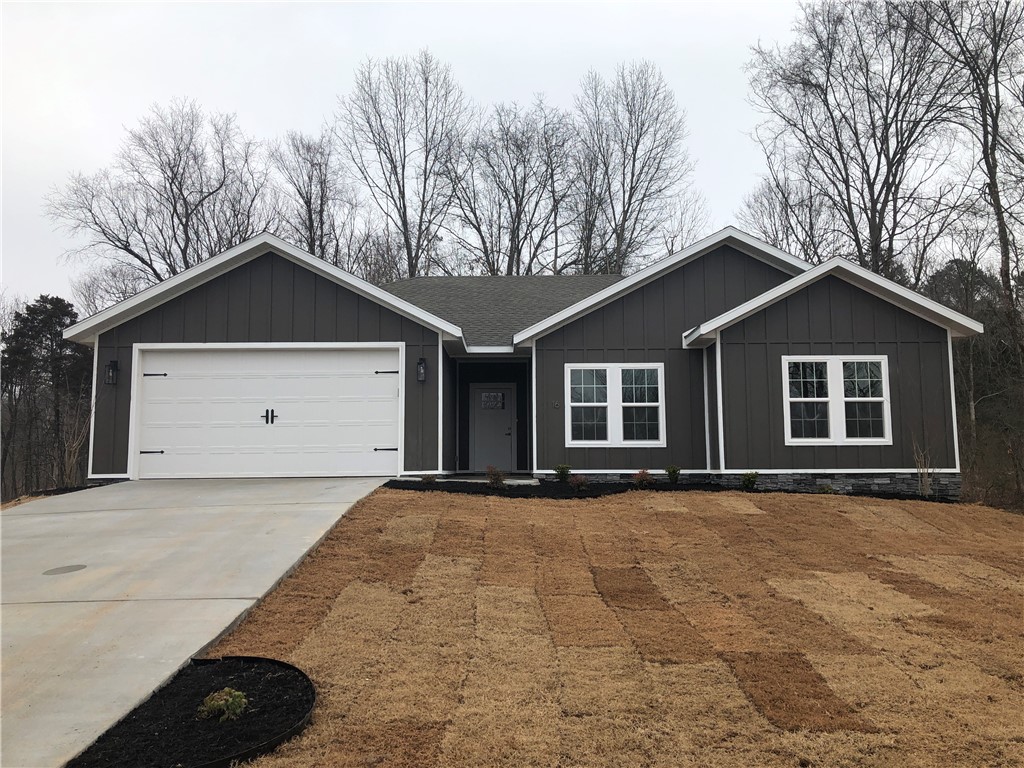 Beautiful like new home with private setting at the end of cul-de-sac.  Convenient access to I-49.  3 Bedroom, 2 bath, granite counters, fireplace, and solid surface flooring throughout.