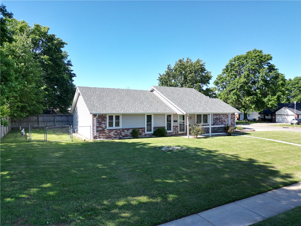 Located in the heart of Springdale, this well-maintained, one-level home offers comfort and convenience on a beautiful corner lot. A brand-new roof installed in 2025 adds peace of mind, while the inviting covered front porch creates the perfect place to relax and unwind. Inside, you’ll find a spacious layout featuring two walk-in closets, and an upgraded handicap accessible walk-in bathtub in the primary suite designed for comfort and accessibility. The kitchen includes an existing gas hookup behind the oven for easy conversion to gas. Refrigerator conveys. Step outside to enjoy the fenced yard—just the right size for gardening, pets, or easy outdoor living without the upkeep of a large yard. Additional features include storm door, insulated garage door, and close location to Lake Fayetteville, Springdale Country Club, NWA Mall, shopping, dining, schools, and everyday amenities. Seller is offering allowance at closing towards buyer’s carpet and/or paint upgrade. Don't miss the chance to tour this home!