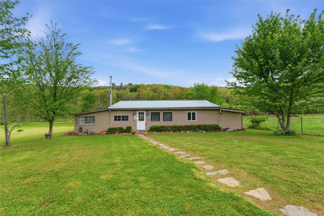 Peaceful acreage with true off-the-grid charm! This 3.86-acre property offers a 1,030 sq ft home surrounded by scenic views and natural beauty, complete with a creek running through the land that adds to the tranquil setting. The home operates on a rainwater system, creating a self-sufficient, eco-friendly lifestyle perfect for those looking to unplug and unwind. Existing septic and electricity are already in place, offering convenience while maintaining that rustic feel. The property also features an 18x30 shed with electricity—ideal for a workshop, storage, or hobby space. A rare opportunity to own a private retreat with space, serenity, and endless potential.