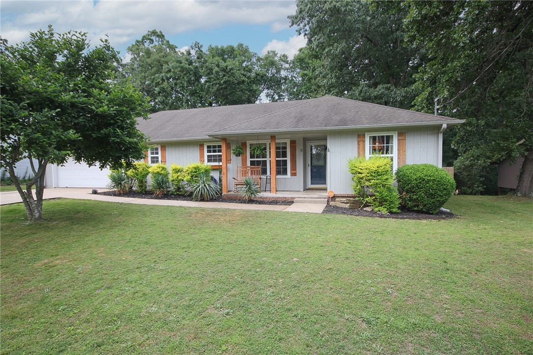 Prime location just a 2 minute ride to the Back 40 Bike Trail / 5 minute drive from new Bike Park / 71 business. This 1,517 sq ft, 3-bedroom, 2-bath, 2 car garage with workshop, open concept floorplan with a flex room (office) home sits on a private / spacious 0.31-acre lot. Features include a screened-in back porch, a oversized, flat, fully fenced backyard—ideal for year-round outdoor enjoyment. Built in 1997, the home offers numerous updates including a new HVAC system (2022), updated flooring (2025), new fence (2024), remodeled primary bath (2025), updated kitchen (2019), and replaced septic tank (2025). Additional improvements include a new electrical panel (2022), microwave (2022), and dishwasher (2026). Roof will be replaced June 6-7, offering added peace of mind. No showing until roof is replaced and repairs are made.