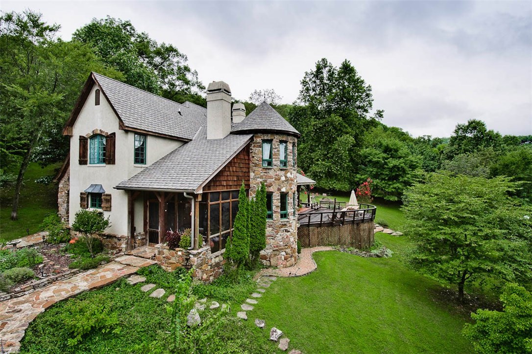 Stunning Beaver Lake home with luxurious finishes & gentle walk to private boat dock. Interior is a masterpiece of design & craftsmanship featuring: 3 fireplaces, 1860's hand hewn cabin beams, antique stained glass door, solid Western Pine slab bar & flooring, restaurant-style 6 burner gas range, sub zero refrigerator. Open living space flows to huge deck with amazing view of the lake & 5.72 acres. Solar-powered boat dock, terraced garden, orchard & stone walkways. Detached 2 car garage with bonus room.
