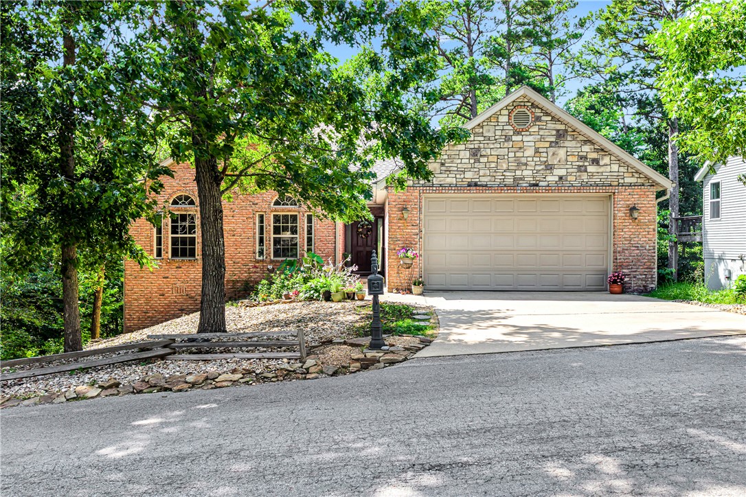 Imagine waking up, grabbing your coffee, and stepping onto your balcony surrounded by towering trees — that's everyday life at 20 Hambleton Dr in Bella Vista! This stunning 3-bed, 2-bath home with 2,172 sq ft includes a fully finished walk-out basement — perfect for a home gym, game room, or guest suite. The roof was replaced in 2019, brand new bedroom carpet was just installed, and this home is already connected to public sewer, saving you thousands. Cozy up to the gas log fireplace on cool Ozark evenings, then spend your weekends riding the legendary Back 40 trails literally minutes from your door. Bella Vista living means access to pools, tennis courts, clubhouses, and endless trails — all included with a low $40/month POA. The brick and rock exterior, wooded lot, and spacious patio make this home as beautiful outside as it is inside. This is the lifestyle you've been looking for, and at $380,000, it won't last long. Come see it before someone else calls it home!