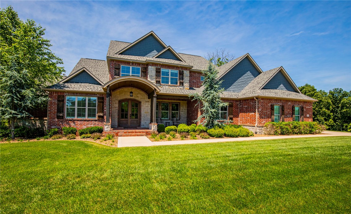 Combining Quality, Luxury, Design and Comfort, this custom built one-owner home truly has it all. Soaring ceilings with expansive windows capture the beauty of the wooded privacy view you can enjoy year round. Thought and meticulous care went into the design and construction, making this home stand apart. Downstairs features a large bonus room with a wall of windows and kitchen area, perfect for entertainment and fun. Just wait ‘til you see the golfer’s dream featuring your own golf simulator room! Exercise room with added craft/bonus space and perfect in-law/guest suite complete the downstairs. Rugged beams are showcased at the ceiling and can be seen from the main and the upstairs level. Natural lighting from the abundance of windows is so inviting and the open floor plan is one you’ll love!