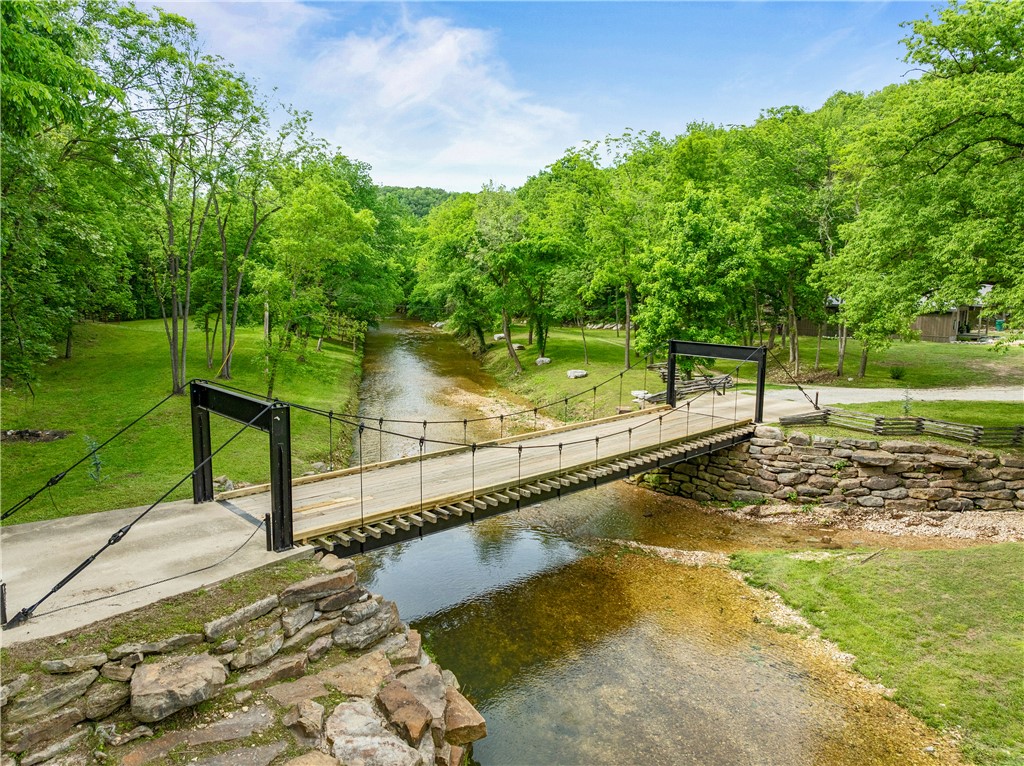 Nestled on 40 private acres near the Buffalo National River, The Creek Cabins at Brush Creek offer a unique retreat surrounded by natural beauty. Guests arrive via a picturesque creek crossing and enjoy rock terraces, creekside lawns, and peaceful outdoor spaces. Located just 4 miles from the river, 15 minutes from a canoe outfitter, and under 4 miles from town, it blends seclusion with convenience.

Operating as a successful Airbnb and wedding venue, each stay features a signature boulder hot tub for ultimate relaxation. Creek’s Edge Cabin offers modern rustic comfort along Brush Creek. Dry Creek Cabin provides a cozy, open-concept space with full kitchen. Sky View Yurt sits elevated with scenic views, while Stone’s Throw Lodge, nearly 3,000 sqft, includes 3 bedrooms, 2 baths, and a spacious deck—perfect for groups and gatherings.