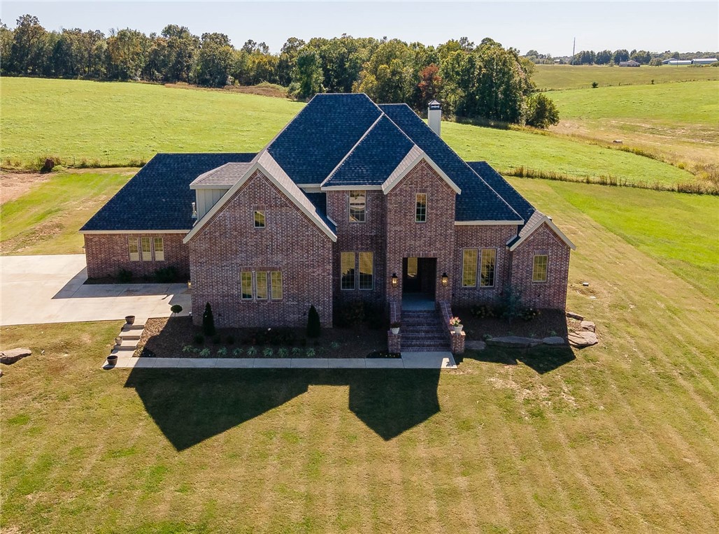 Looking for quality new construction but do not want to build??? Here is your chance to own a just like new home in a prime location situated on 1.79 acres! 3,691 heated square feet includes 4 bedrooms, 4 full bathrooms, study, formal dining, oversized living room open to eat in kitchen, large laundry, mud room, and a bonus room (which offers a closet and could be a 5th bedroom).  Amenities include hardwood floors, wood burning fireplace, cabinets to the ceiling in kitchen, brushed 3 cm granite, walk in pantry, double ovens, 5 burner gas range, mud room lockers, and large covered patio.  Extra special features include 2 bedrooms on the main floor, an amazing 4 car garage of which 1 is heated and cooled with a mini split, and an abundance of walk in attic storage.  The property offers a country feel with a 20 minute drive to Fayetteville or a 20 minute drive to Bentonville!!! Zoned for Harber HS.