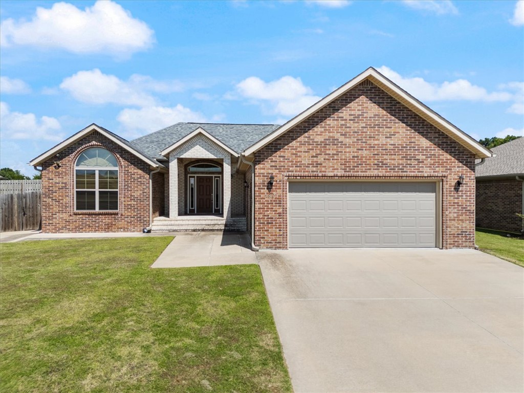 Like new and move-in ready! This beautiful 3-bedroom, 2-bath home offers 1,919 sq. ft. of comfortable living space in a desirable neighborhood just minutes from schools, parks, the Siloam Springs Aquatic Center, downtown Siloam Springs, and John Brown University. The open floor plan features durable hard-surface flooring throughout—no carpet! The spacious living room is highlighted by a cozy fireplace and flows seamlessly into the kitchen and dining area, making it ideal for everyday living and entertaining. The kitchen features granite countertops, ample cabinetry, and plenty of workspace. The private primary suite offers a relaxing retreat, while two additional bedrooms provide flexibility for family, guests, or a home office. Enjoy the covered back porch overlooking the backyard with open land behind the property, offering added privacy and a peaceful view. A great combination of location, style, and low-maintenance living!