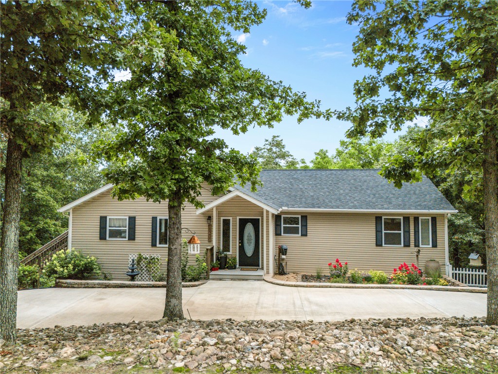Nestled in the heart of the Ozarks, this secluded 4-bedroom, 3-bath home offers the perfect blend of privacy, comfort, and breathtaking mountain views. Surrounded by mature woods, you'll enjoy peaceful mornings, abundant wildlife, and the serenity of nature. Inside, the spacious floor plan includes a large family room in the walkout basement, providing the ideal space for entertaining, hobbies, or multi-generational living. Step outside to an expansive deck overlooking the scenic landscape, a garden area for your favorite flowers or vegetables, and a unique putting green tucked beneath the deck. A 2-car garage provides ample storage for vehicles and outdoor gear. Whether you're searching for a full-time residence or a private Ozarks retreat, this property offers the space, setting, and lifestyle you've been dreaming of.