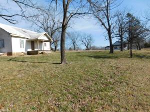 Peaceful Country Setting in Convenient Location for this older 2 bedroom home on 4 acres with 32x36 ft barn/shop building. Land has pasture, fruit trees, and wooded area, terrific building sites, views, Harrison city water available, come enjoy this peaceful country setting only 2 miles from Walmart. House needs major TLC and sold ''as is'' with no repairs by seller.  See aerial map, plat, and restrictive covenants in Documents tab. Note - Property has received multiple offers, see Multi Offer Notification in Documents.